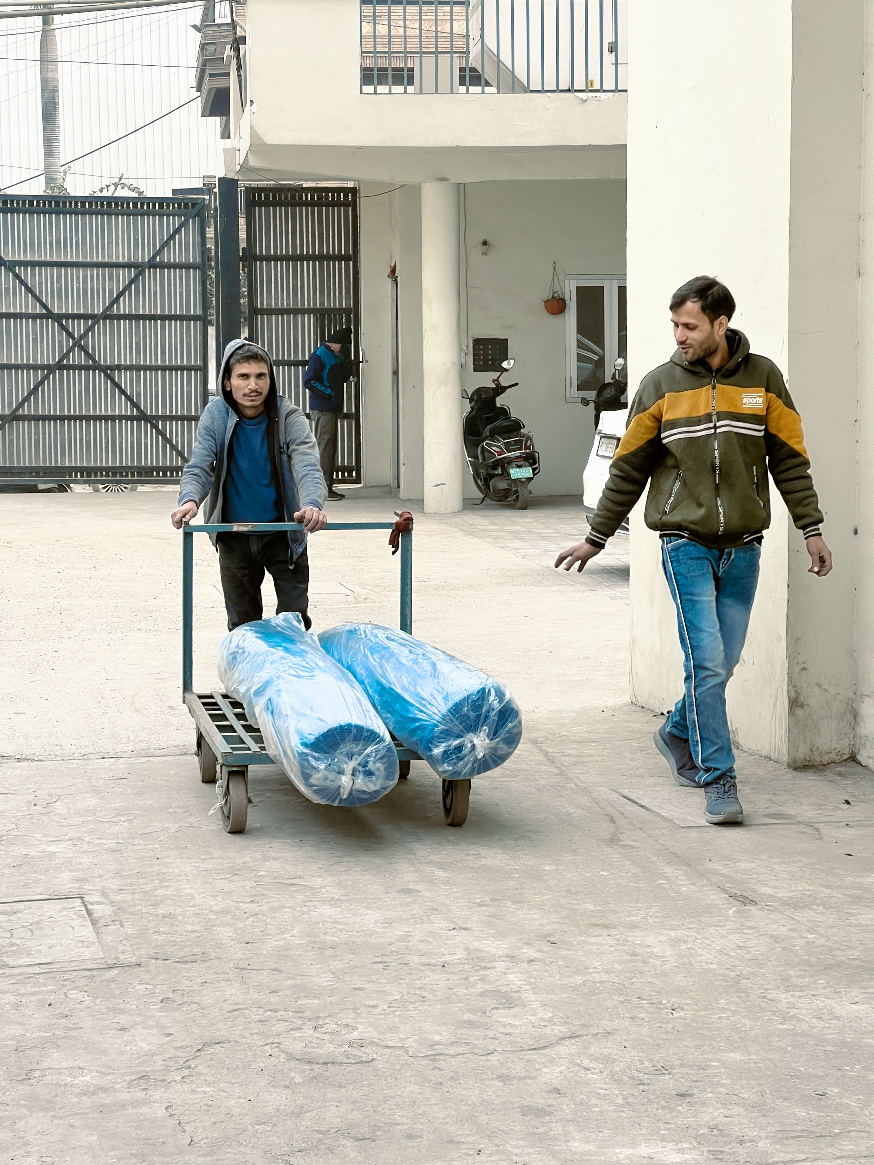 Factory trolley with tubular greige fabric rolls
